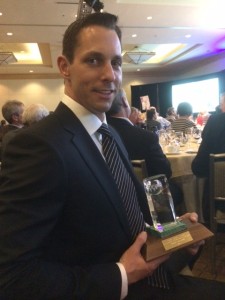 Garrett holding his Colin Spence award (Photo: Ainsworth)