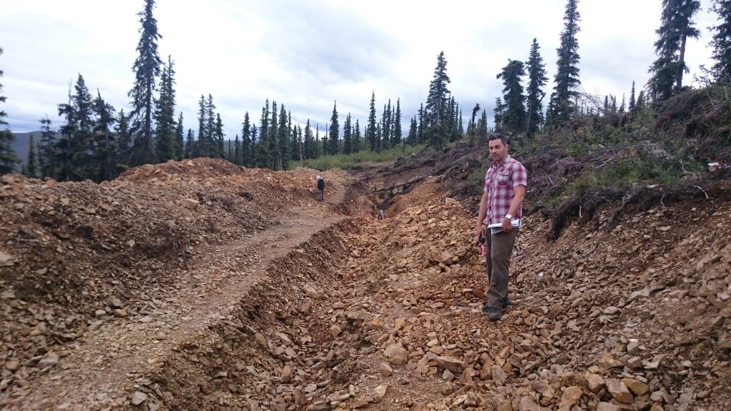 Mr. Reda, VP Corporate Development, has been on the project for over a decade. He explains to us how the gold bearing ore is in the orange-rusted rock in this trench.